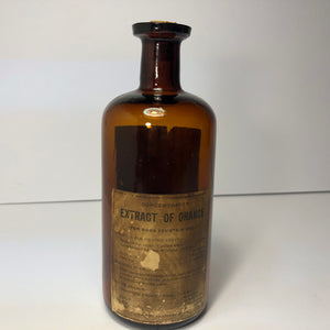 Extract of orange antique bottle, glass with label